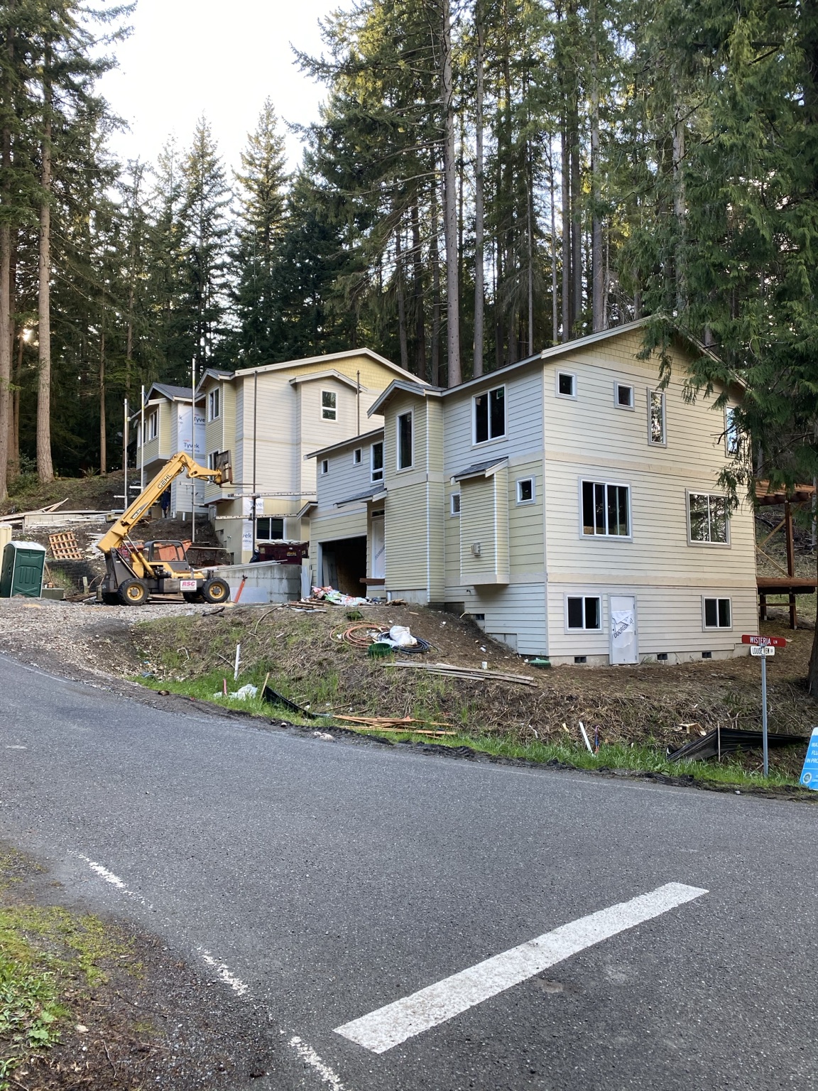 Multiple hillside homes finished with clean siding and trim work